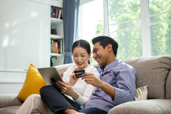 a couple laughing looking at phone