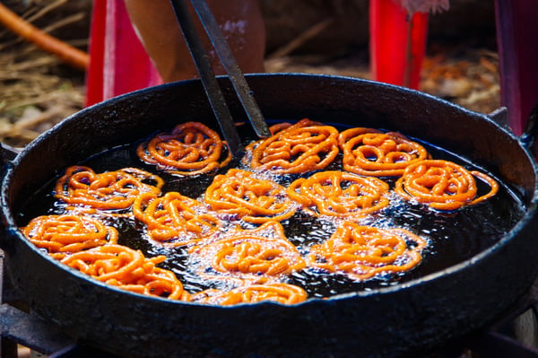 jalebi indian snacks frying in the wok