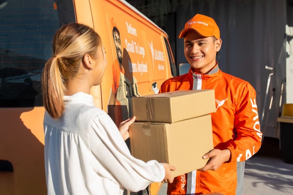 lalamove driver handing over a big box to customer