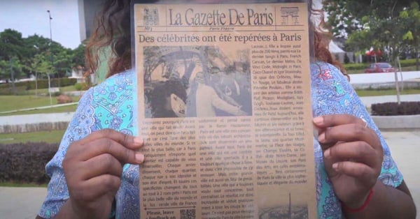 lalamove driver nava showing a newspaper clip of her trip to paris with family