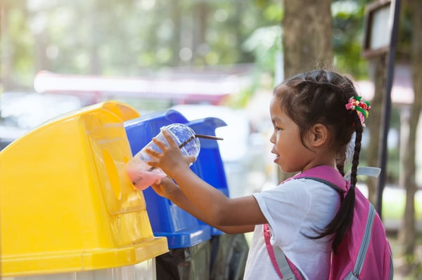 seorang kanak-kanak mengitar semula cawan plastik. barangan kitar semula boleh dihantar dengan lalamove